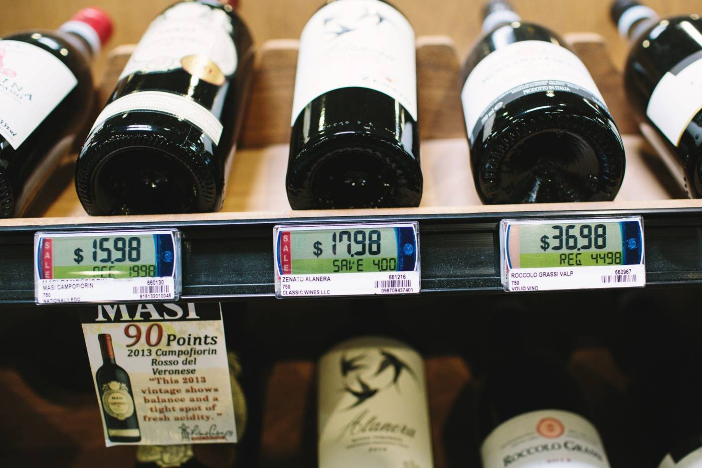 Shelf-edge price tags in the wine aisle of a real mPower customer store